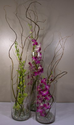 3 cylinders with branches and orchids