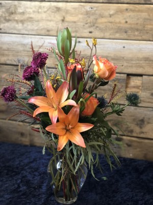 Lily, scabiosa, thistle, leucadendron ($50)