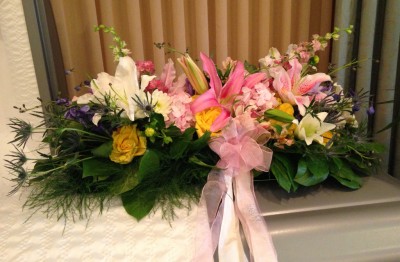 Casket spray with lilies, roses, sea holly