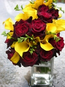 Red roses and yellow calla lilies